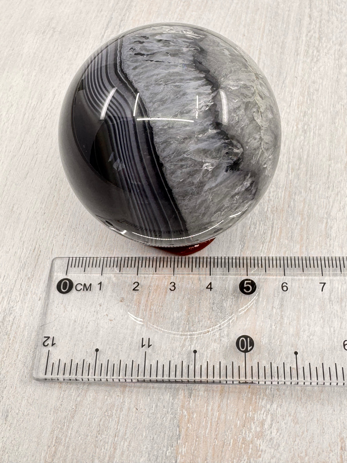 Banded Black Agate Sphere 230g - "I release all behaviours that no longer serve me."