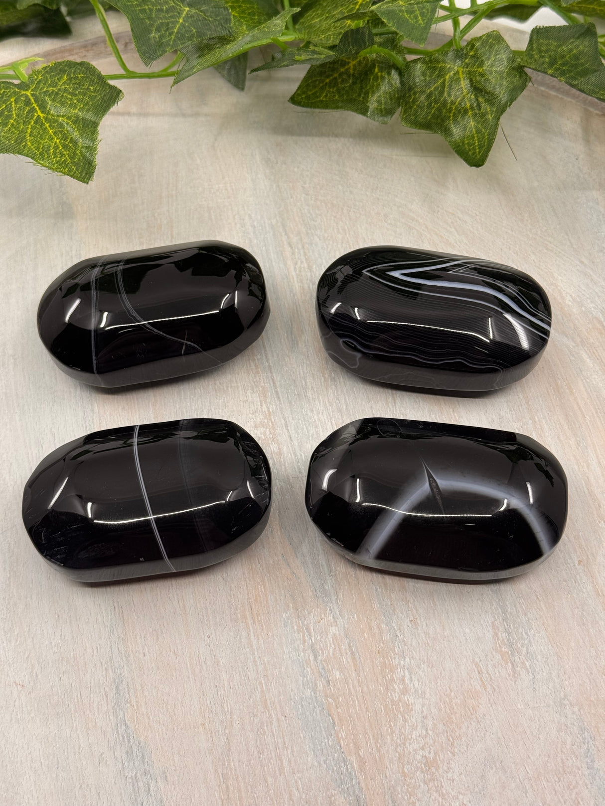 Banded Black Agate Palmstone - "I release all behaviours that no longer serve me."