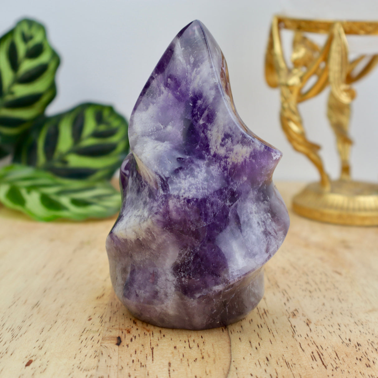 542g Amethyst flame crystal sculpture measuring 11.5cm x 7cm with deep purple tones and natural quartz veining displayed on wooden surface.