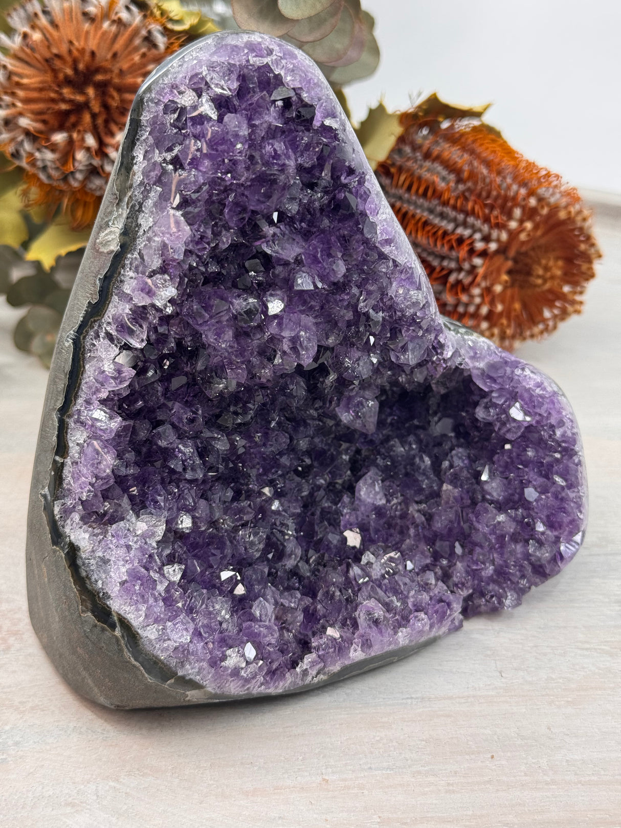 Amethyst cluster crystal with deep violet points for spiritual connection.