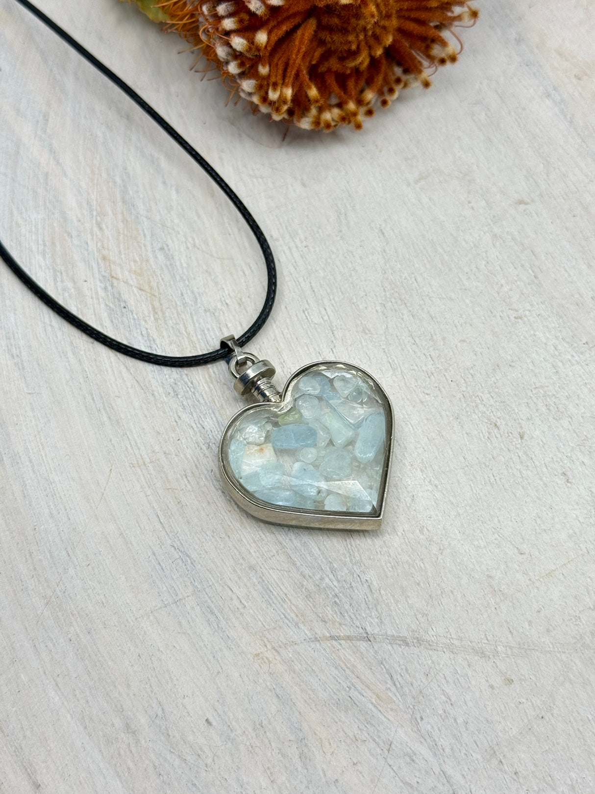 Aquamarine heart bottle pendant 40x32x11mm glass with platinum-plated alloy – filled with blue crystal chips for serenity, courage and clear communication – Inspired By 3 Crystals Australia.