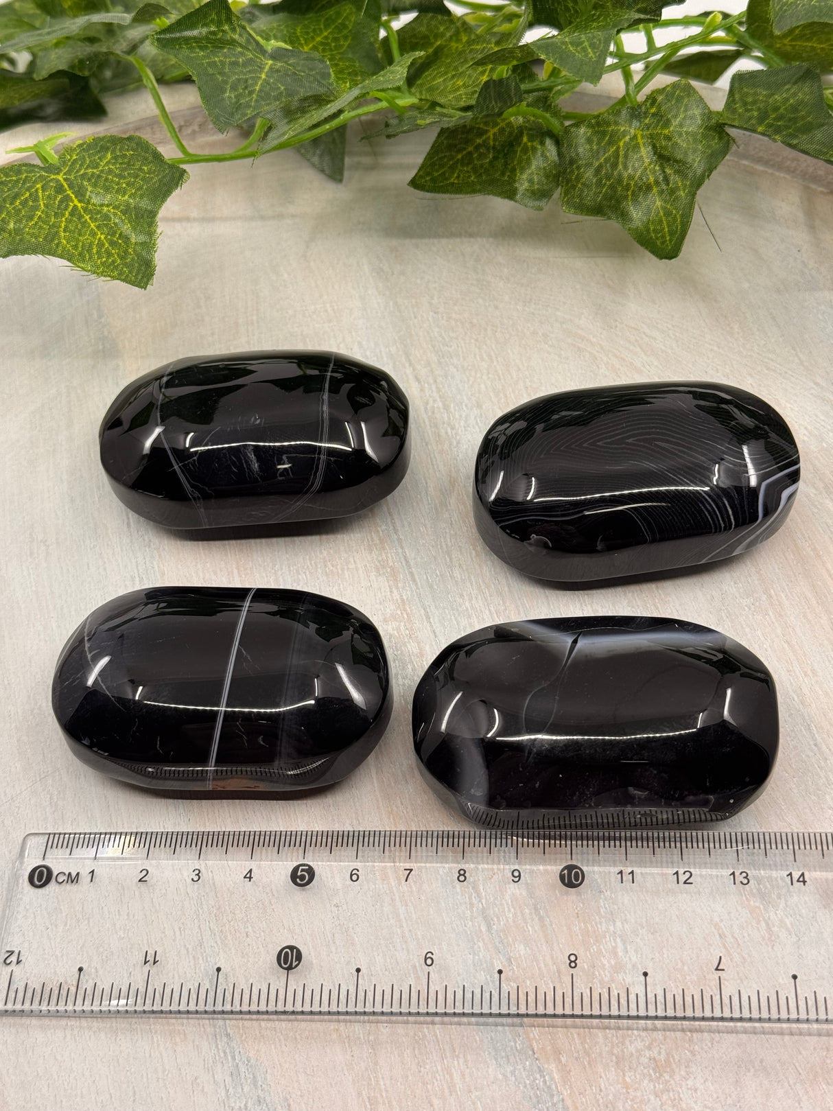 Banded Black Agate Palmstone - "I release all behaviours that no longer serve me."