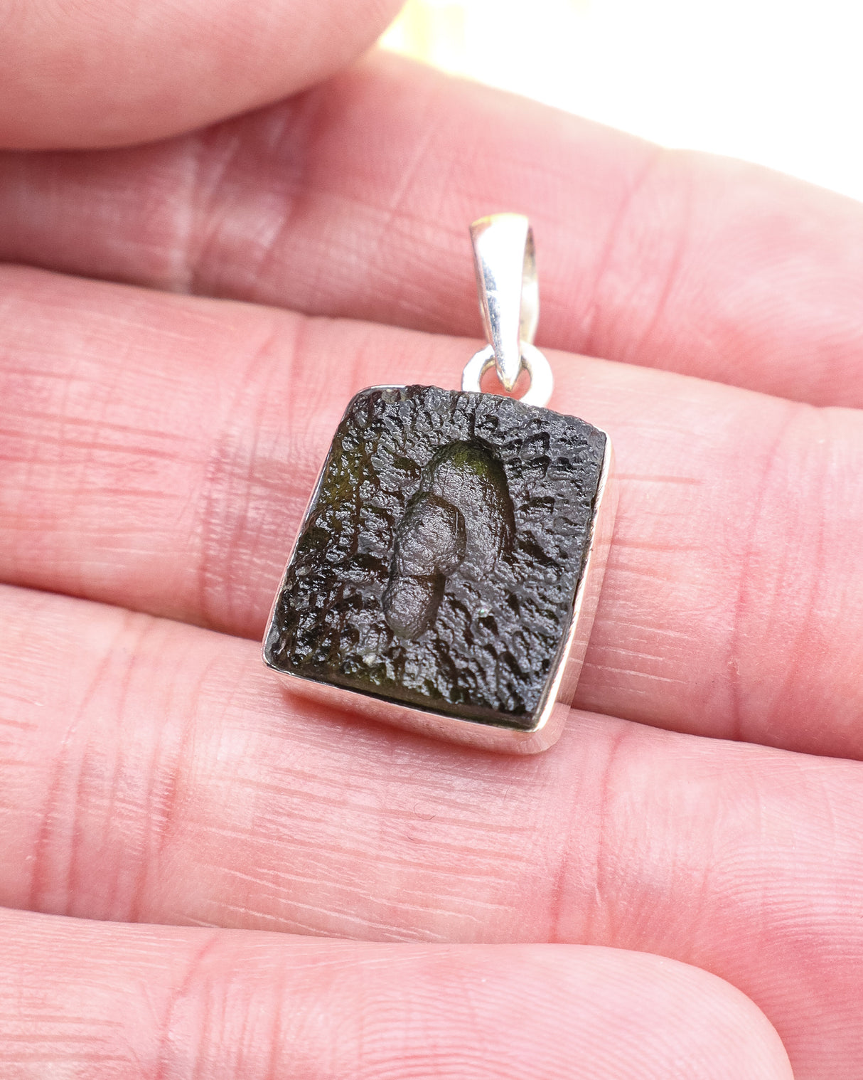 Genuine Czech Moldavite pendant in .925 sterling silver featuring a rare portal-like natural formation, deep green colouring and powerful spiritual awakening energy.