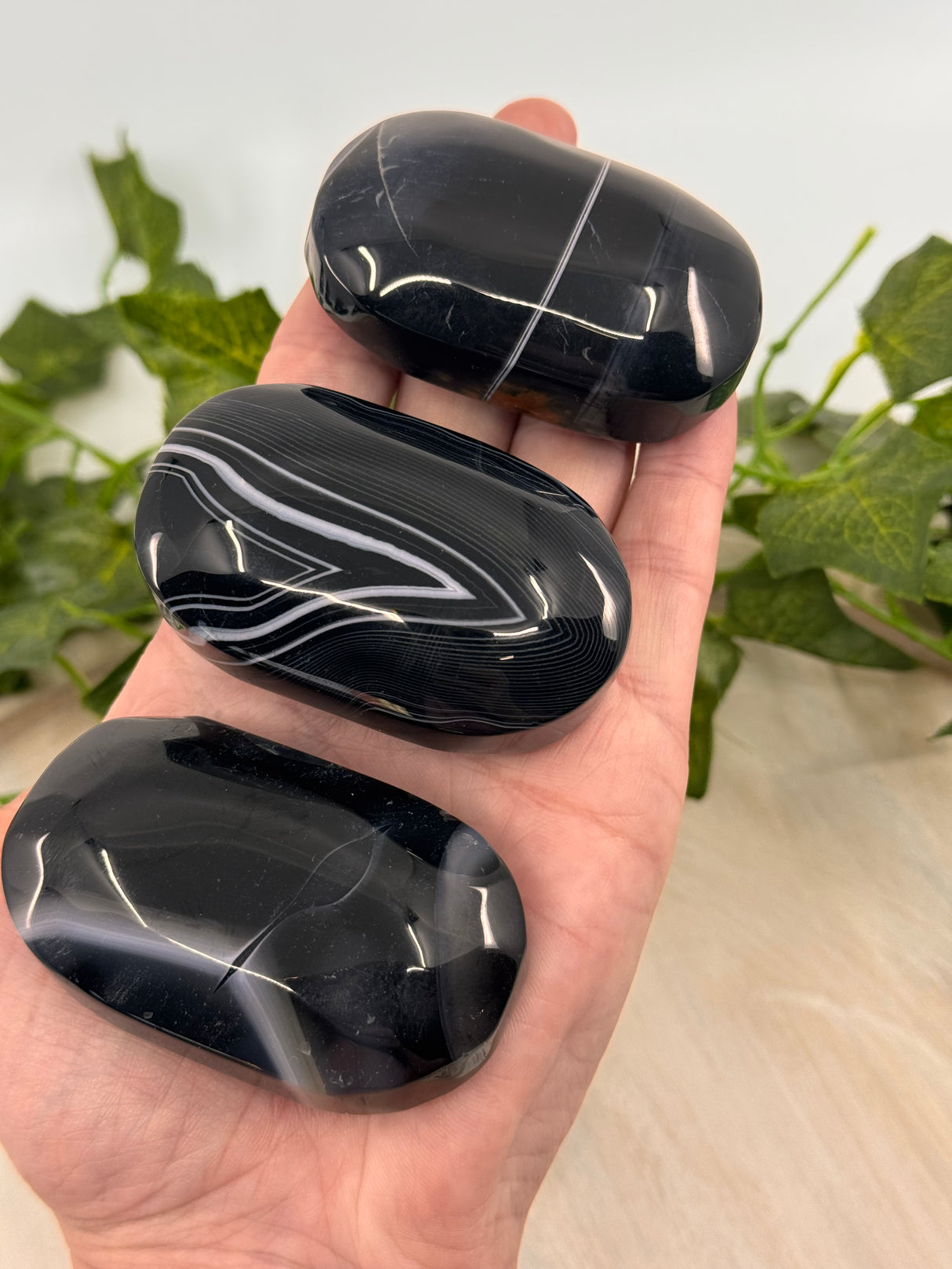 Banded Black Agate Palmstone - "I release all behaviours that no longer serve me."