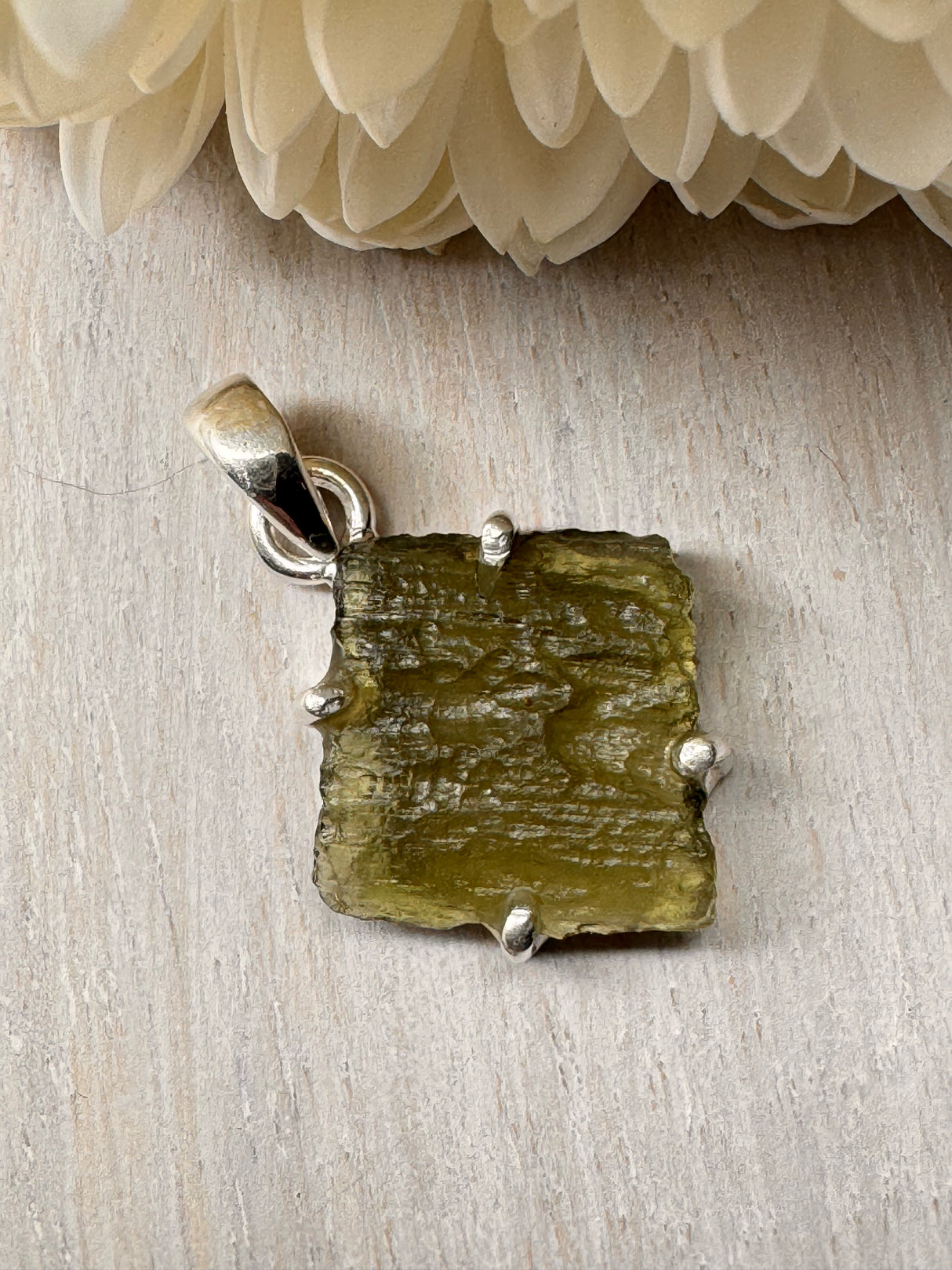 2.6g Moldavite silver pendant in .925 sterling silver, raw textured surface, shown on light background