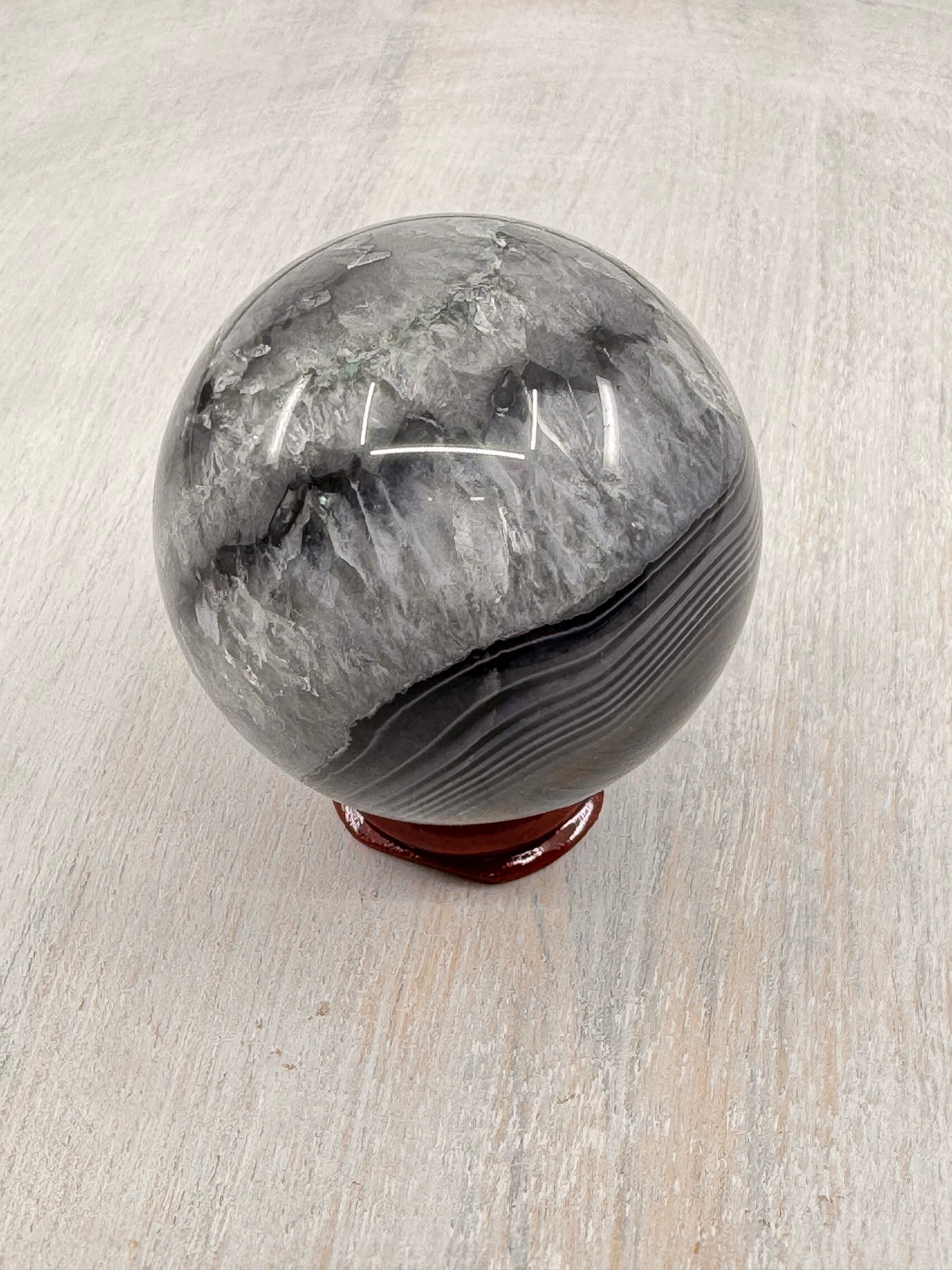 Banded Black Agate Sphere 230g - "I release all behaviours that no longer serve me."