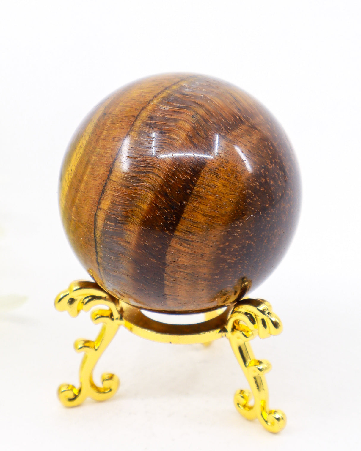 210g Tiger Eye Gold Sphere displaying rich golden chatoyancy with warm honey, bronze and deep earthy brown natural bands on a polished crystal sphere.