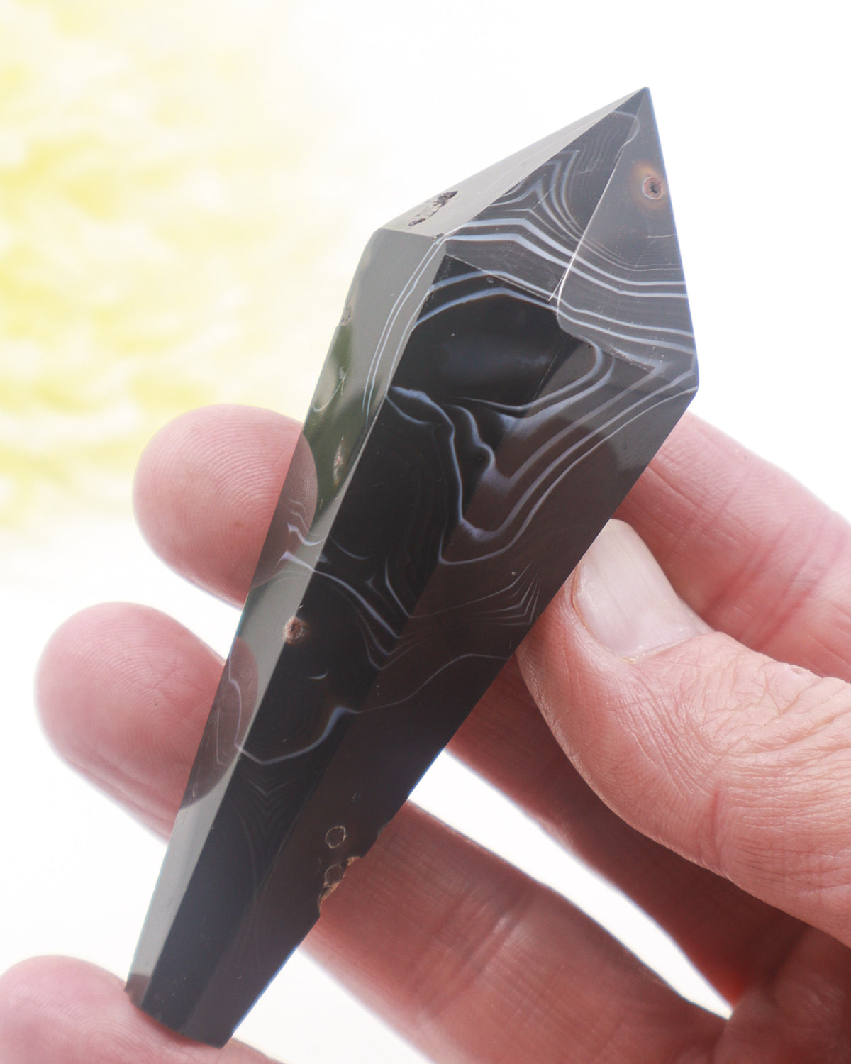 Black Agate crystal wand 72g 9.8cm with striking grey white natural banding, polished point and natural mineral cavities.