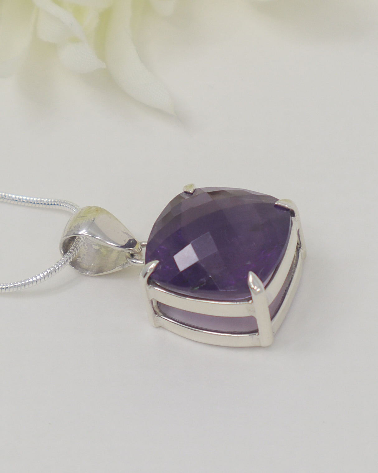 High quality faceted Brazilian Amethyst cushion pendant in 0.925 sterling silver with complimentary silver snake chain.