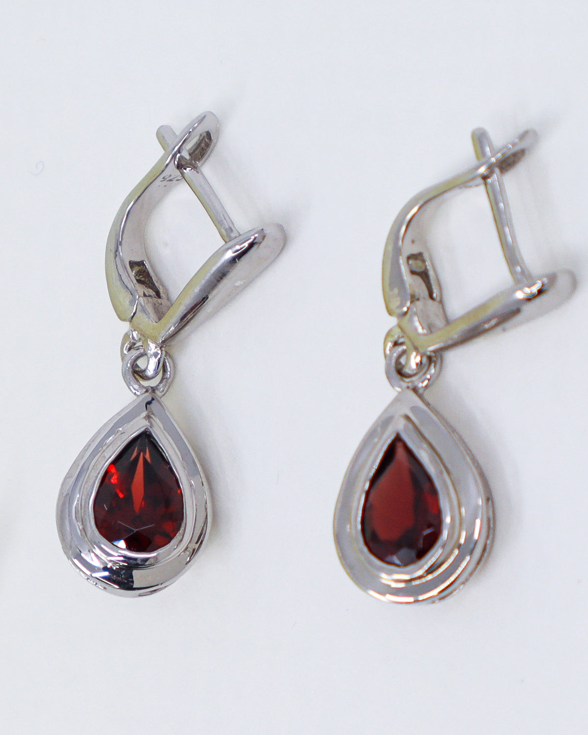 Natural Garnet sterling silver drop earrings with faceted pear shaped deep red Garnet gemstones in polished .925 silver settings.