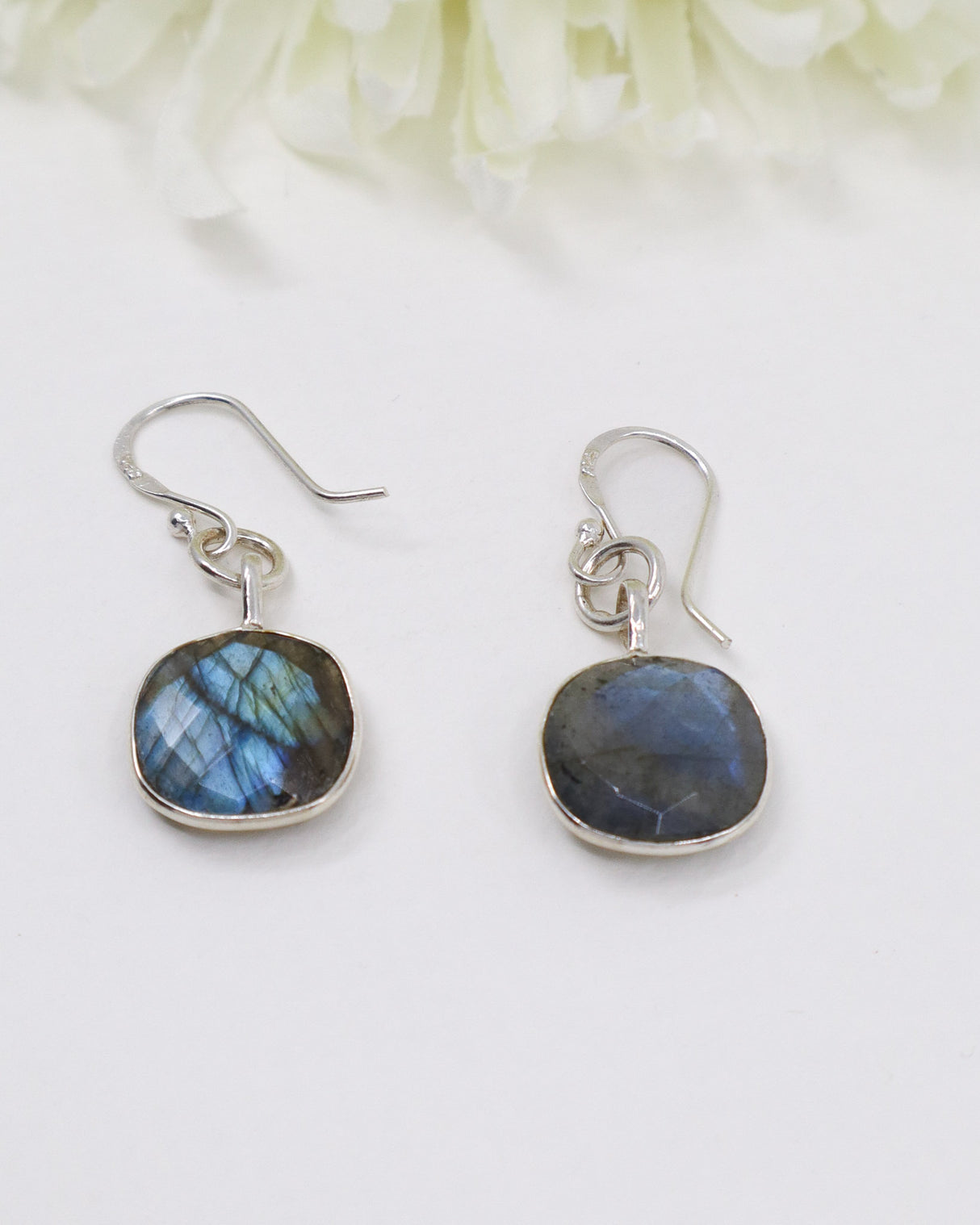 Natural Labradorite sterling silver earrings with vivid blue flash labradorescence photographed on a soft cream background by Inspired By 3 Australia.
