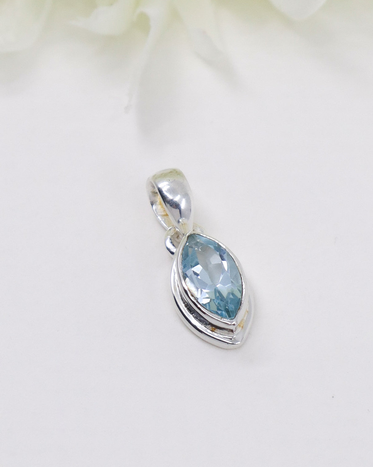 Blue Topaz .925 sterling silver marquise pendant with faceted pale blue gemstone and polished silver setting.