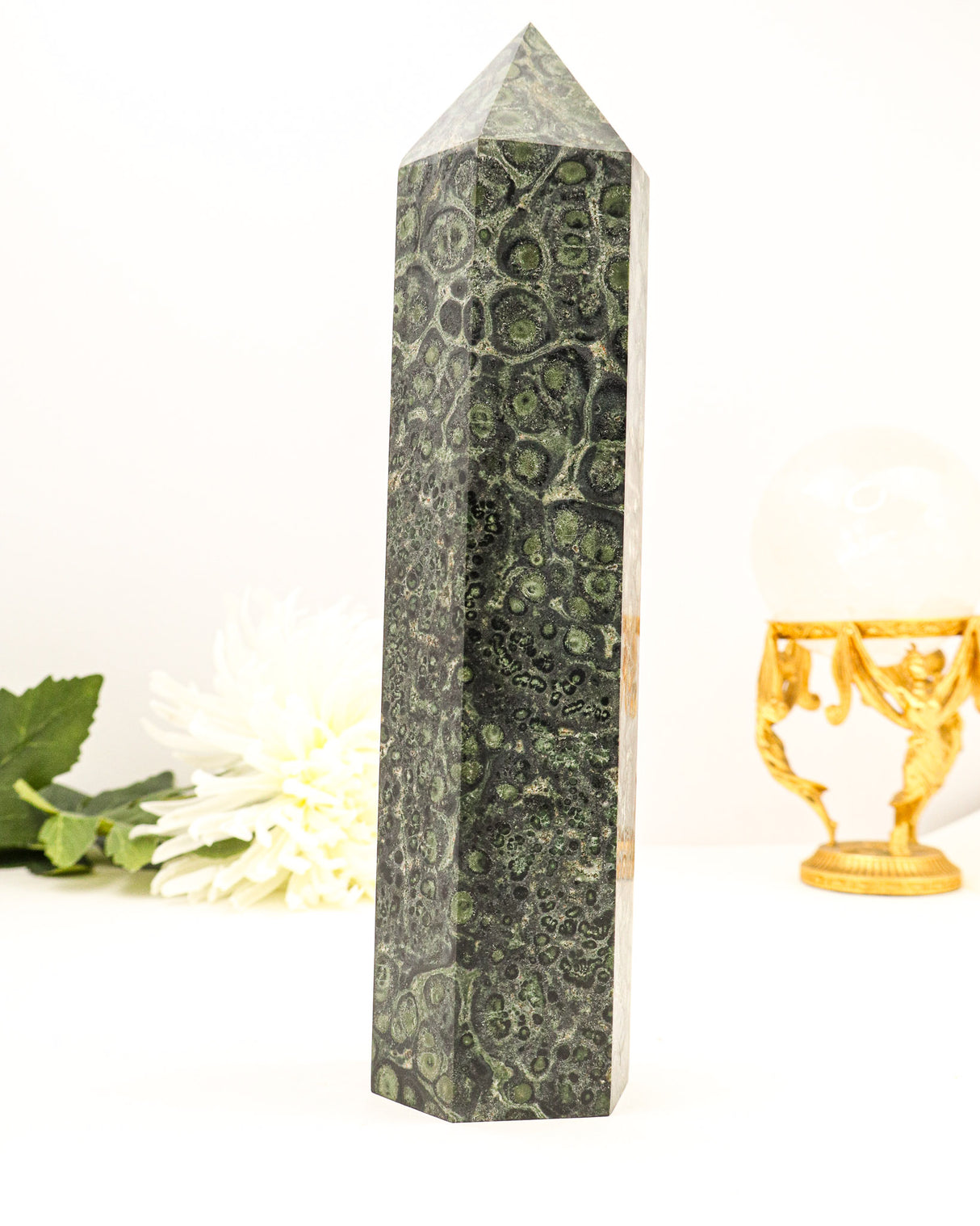 Large polished Kambaba Jasper crystal tower with deep green orbicular patterns and grounding earthy tones.