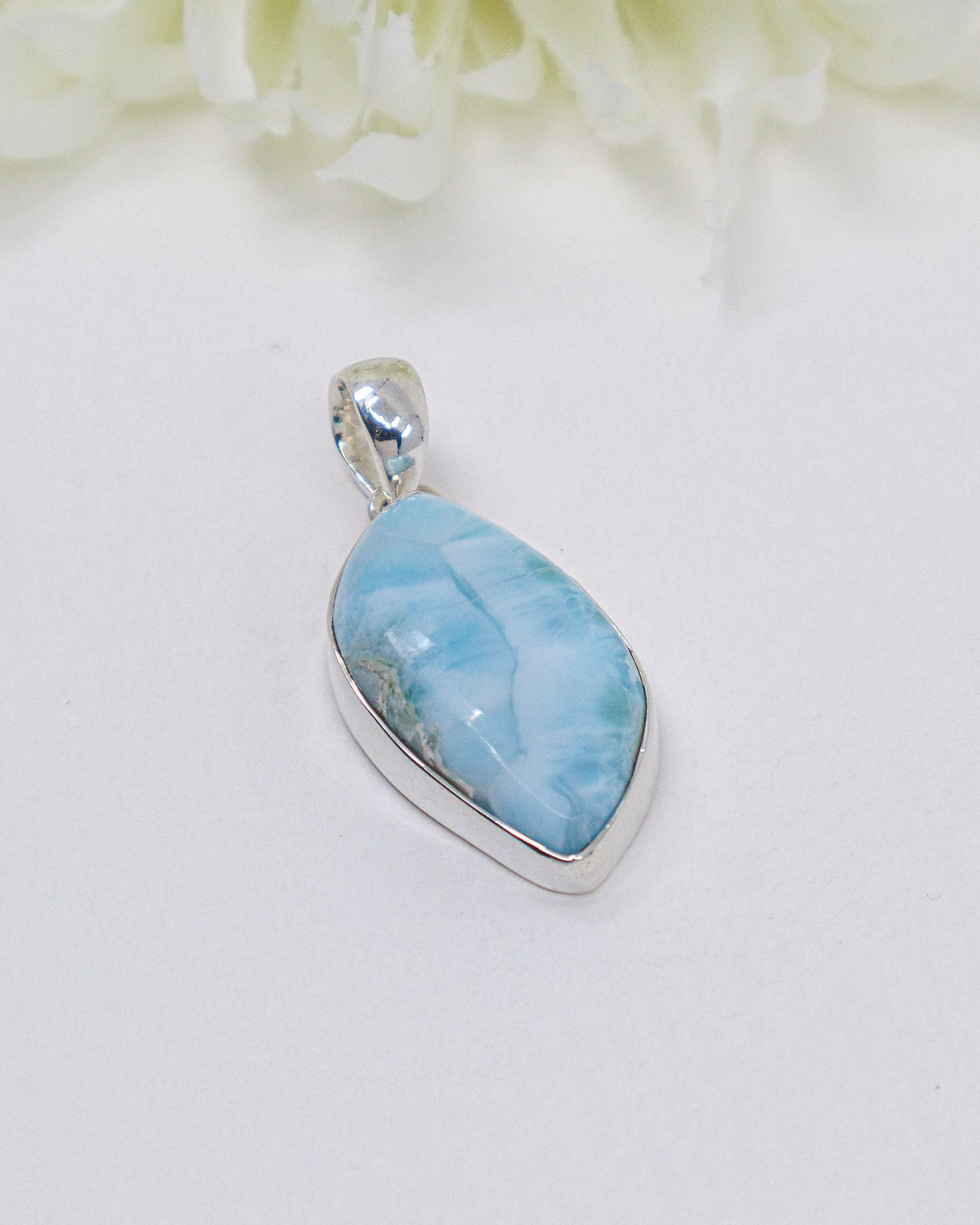 Pear shaped Larimar silver pendant with soft ocean-blue natural patterns set in polished sterling silver.