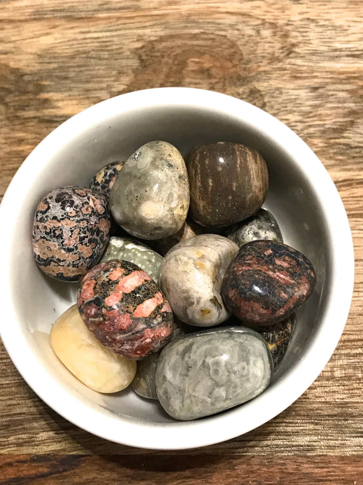 Ocean Jasper tumbled stone with swirling pink, green, and cream patterns — crystal of joy, renewal, and emotional healing.