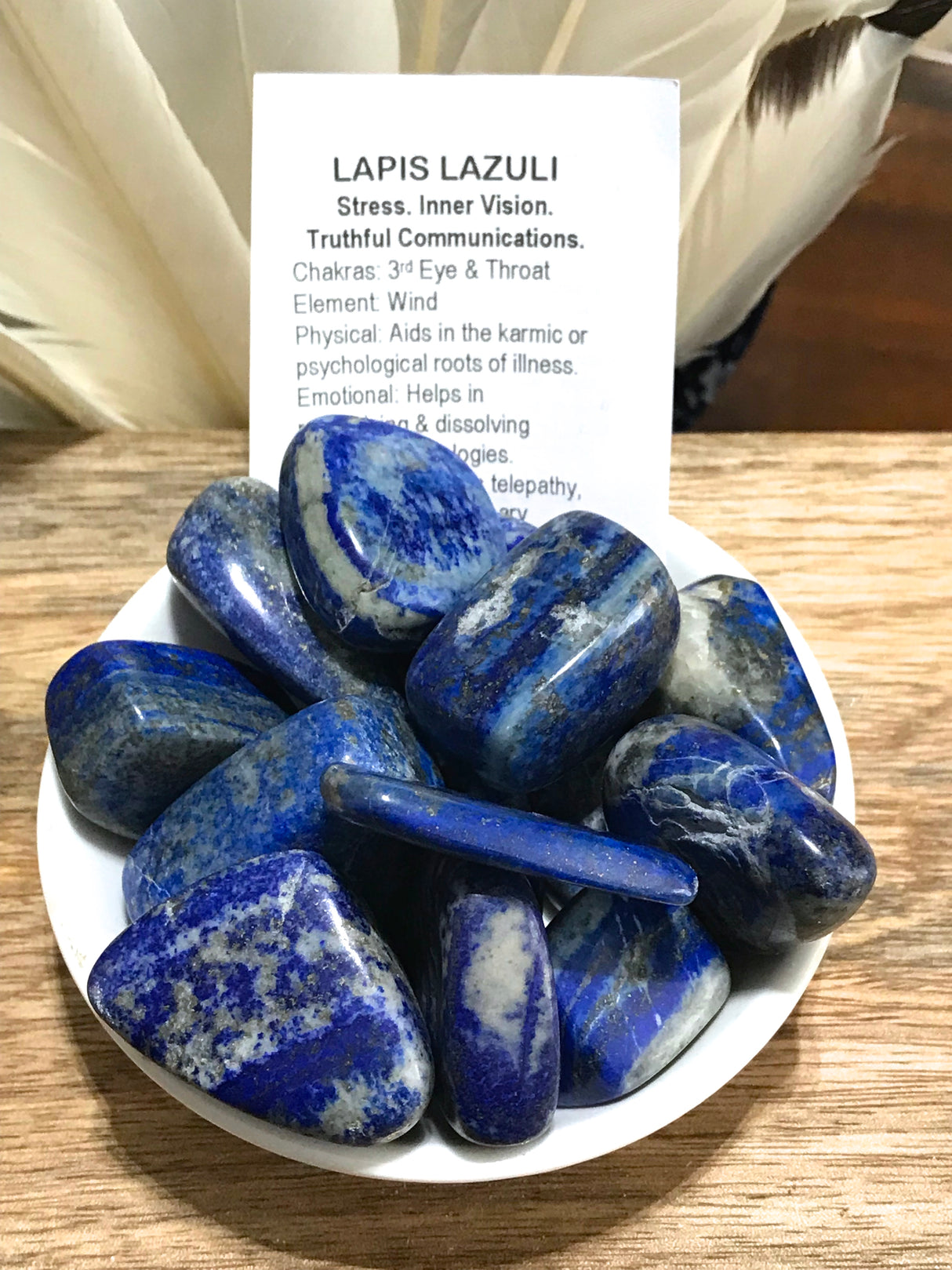 Lapis Lazuli tumbled stone in deep royal blue with golden flecks — crystal of wisdom, truth, and spiritual awakening.