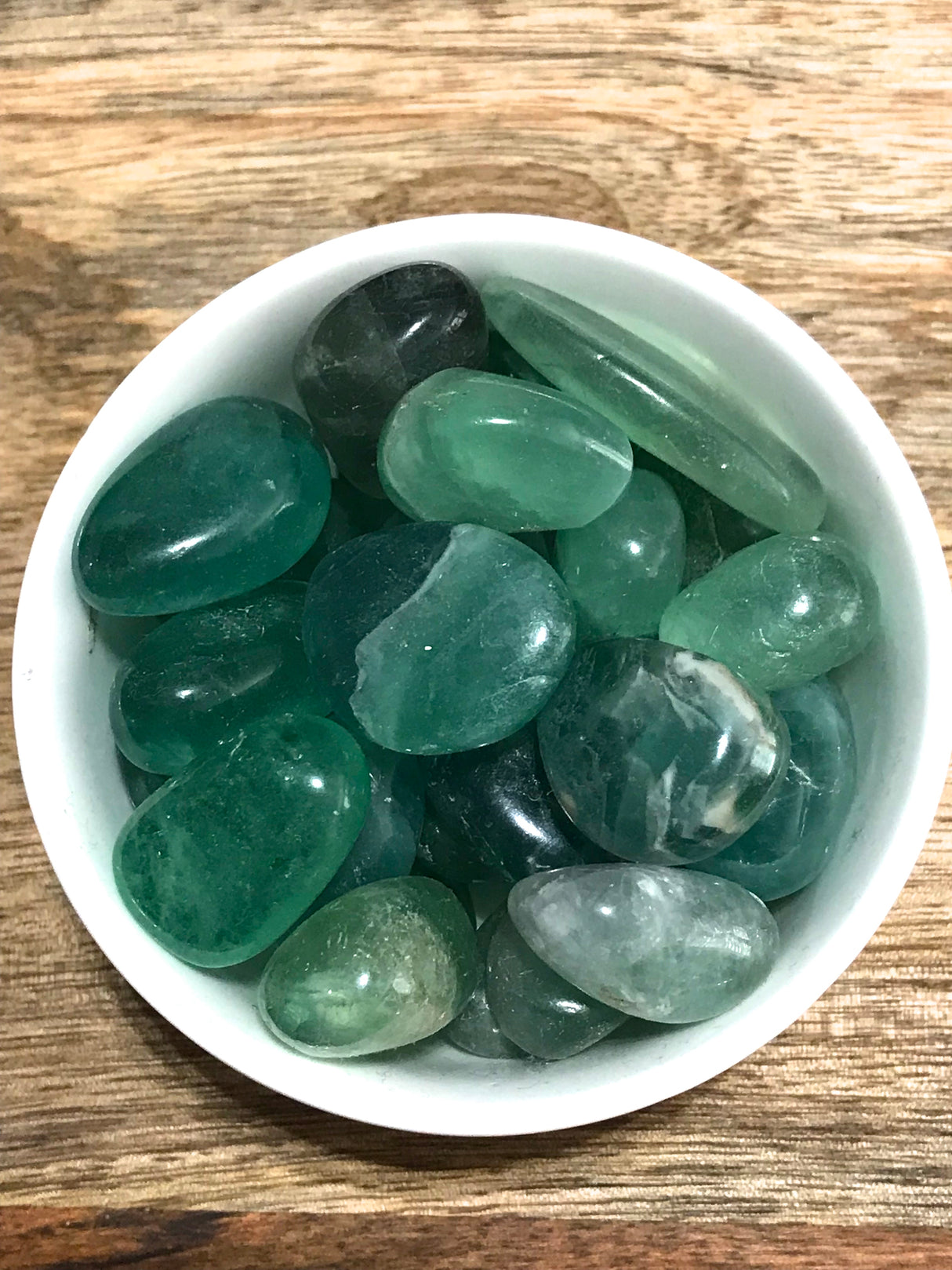 Green Fluorite tumbled stone in soft green tones — crystal of renewal, healing, and heart alignment.
