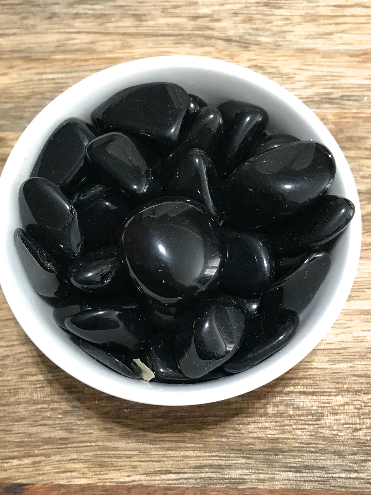 Black Obsidian tumbled stone with glossy finish — crystal of protection, truth, and deep transformation.
