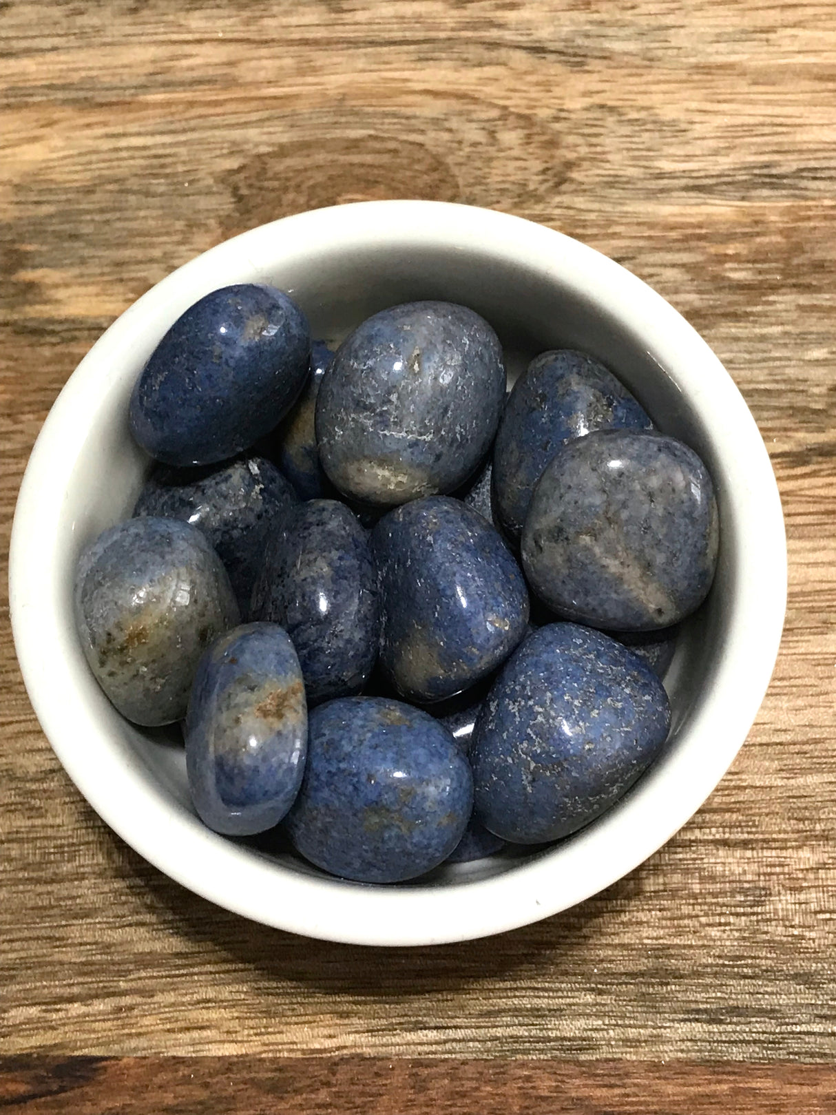 Dumortierite tumbled stone in deep indigo-blue tones — crystal of patience, intuition, and mental clarity.