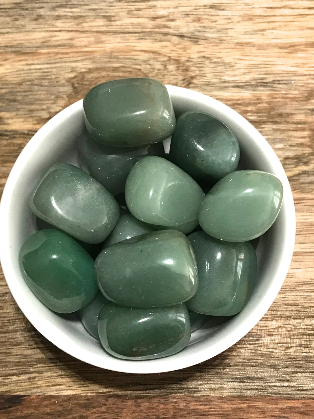 Green Aventurine tumbled stone with soft green shimmer — crystal of luck, growth, and emotional renewal.