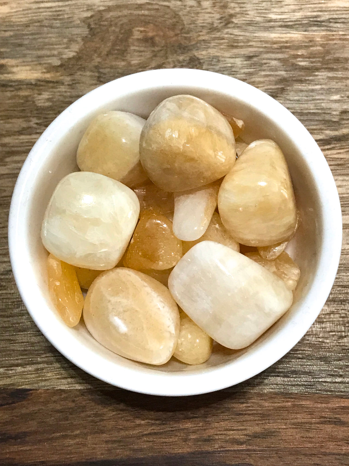 Yellow Calcite tumbled stone in warm golden tones — crystal of confidence, energy, and joyful empowerment.