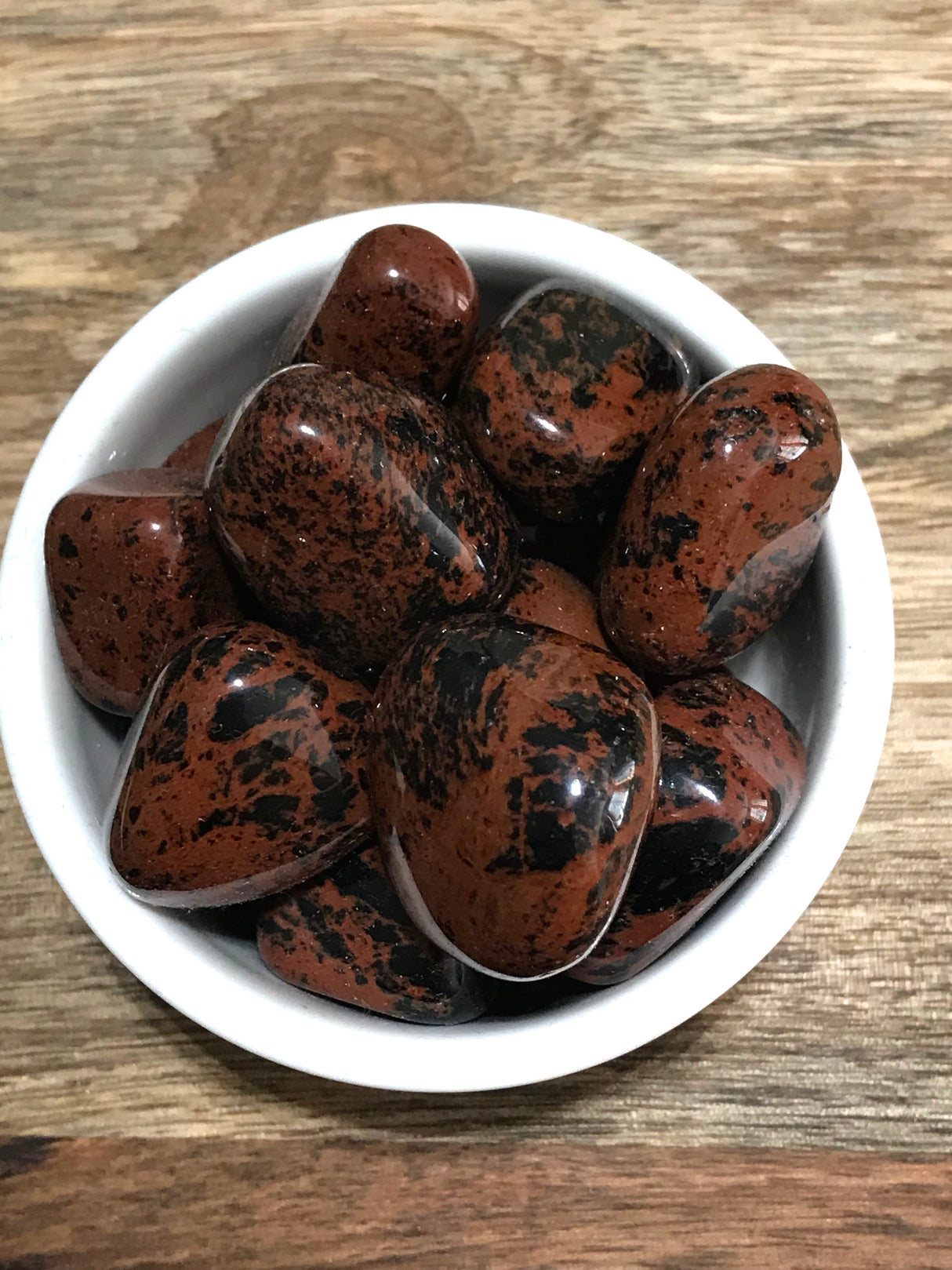 Mahogany Obsidian tumbled stone with deep red-brown and black tones — crystal of strength, grounding, and protection.
