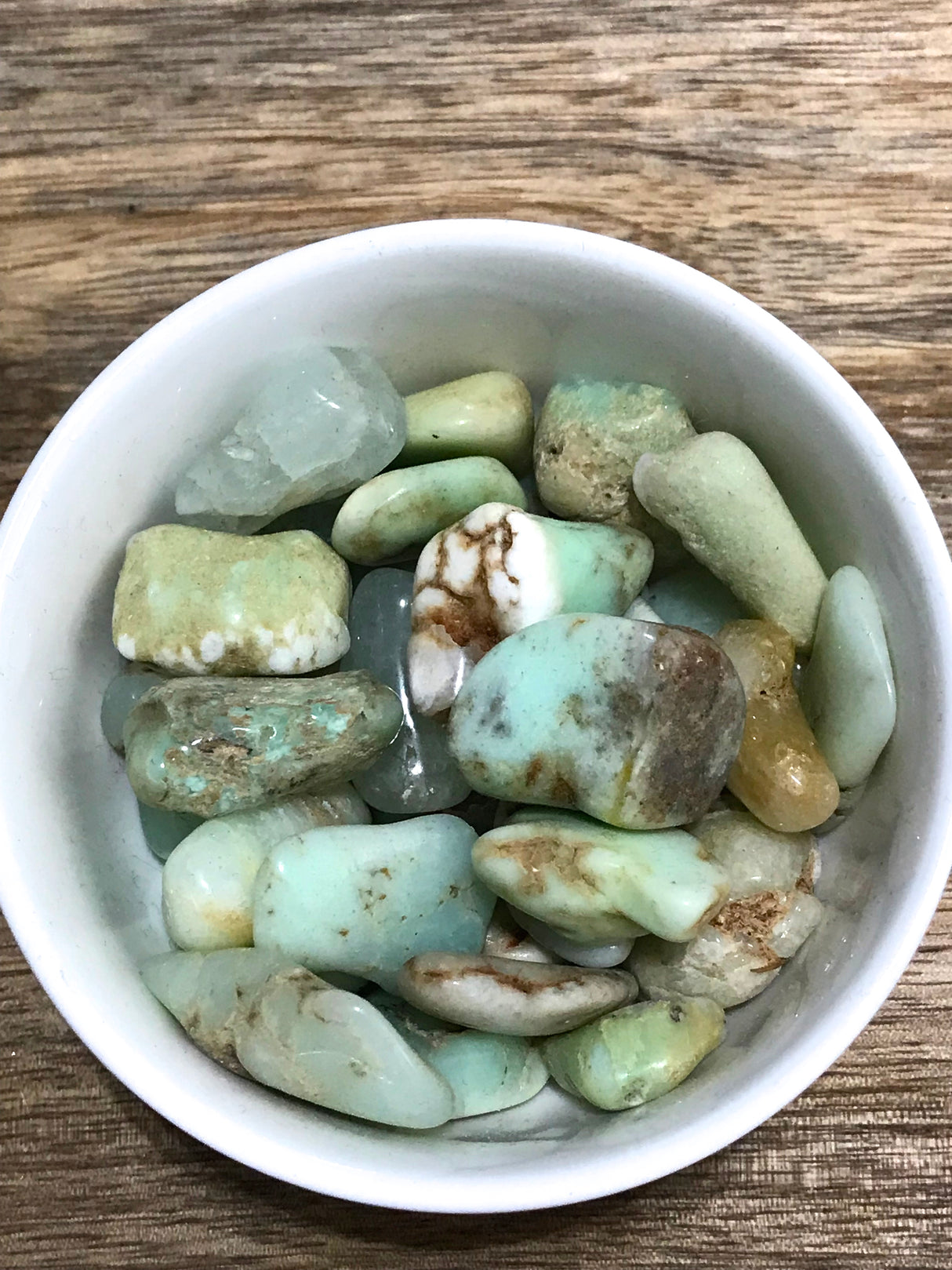 Chrysoprase tumbled stone in bright apple-green tones — crystal of joy, healing, and abundance.