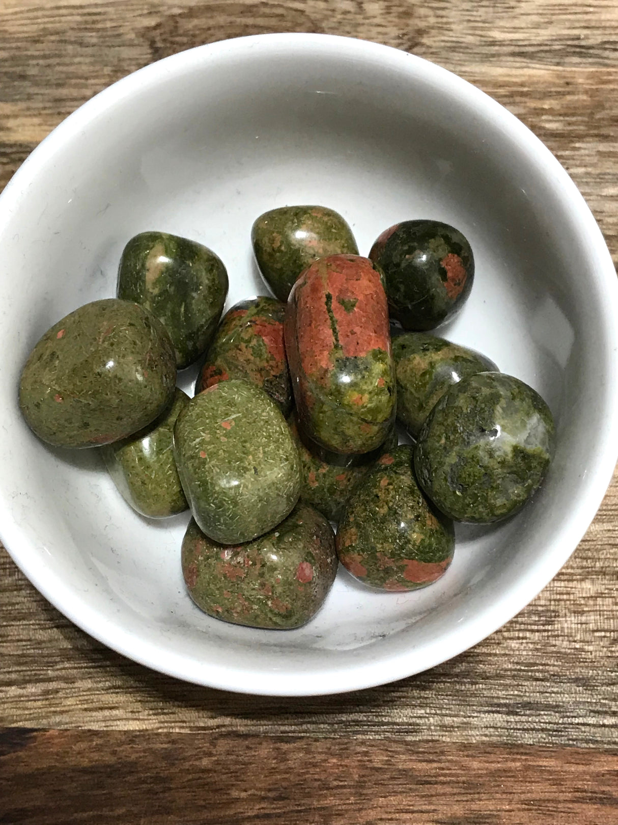 Unakite tumbled stone in pink and green tones — crystal of healing, balance, and emotional growth.