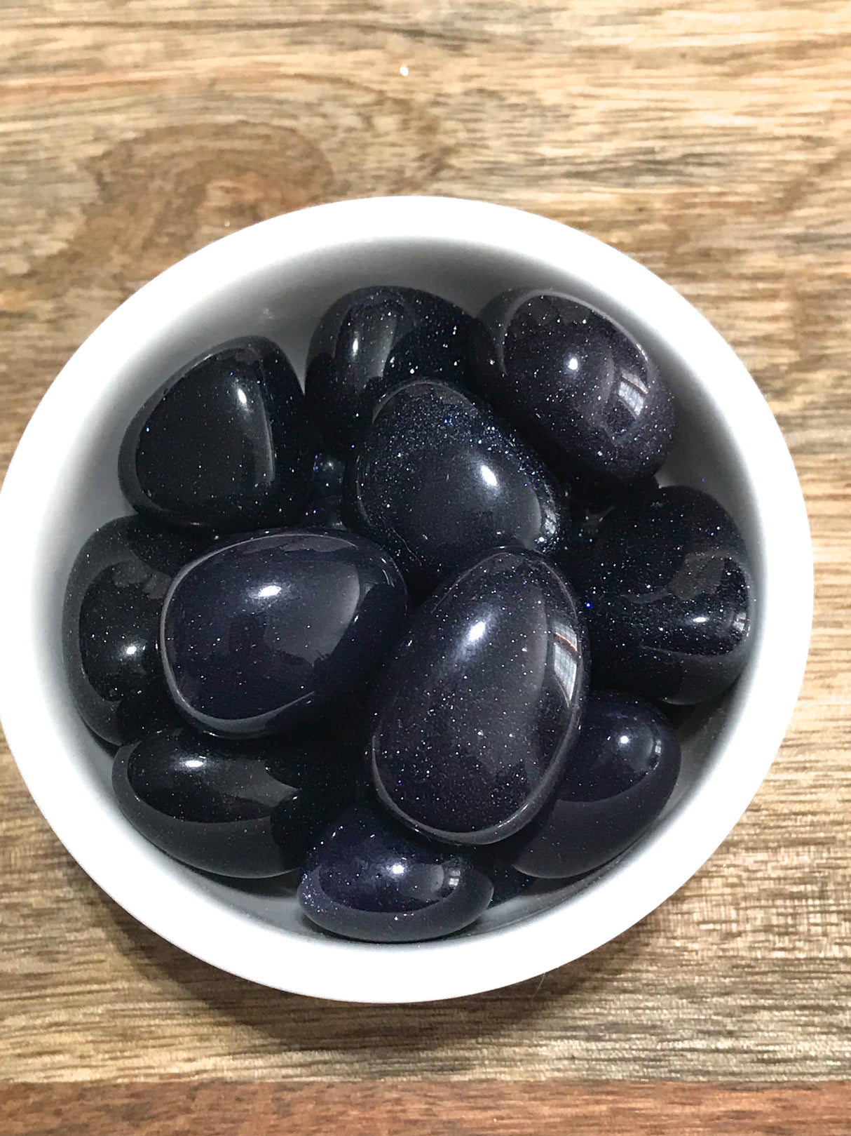 Blue Goldstone tumbled stone with sparkling copper flecks — crystal of ambition, confidence, and cosmic connection.