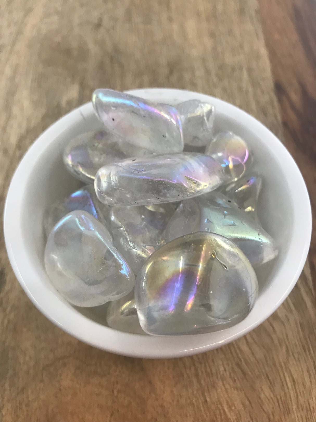 Angel Aura Quartz tumbled stone with rainbow sheen — crystal of joy, angelic connection, and spiritual light.