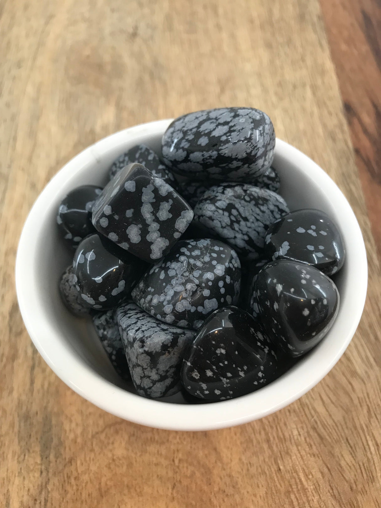 Snowflake Obsidian tumbled stone with white snowflake patterns — crystal of balance, purity, and inner strength.