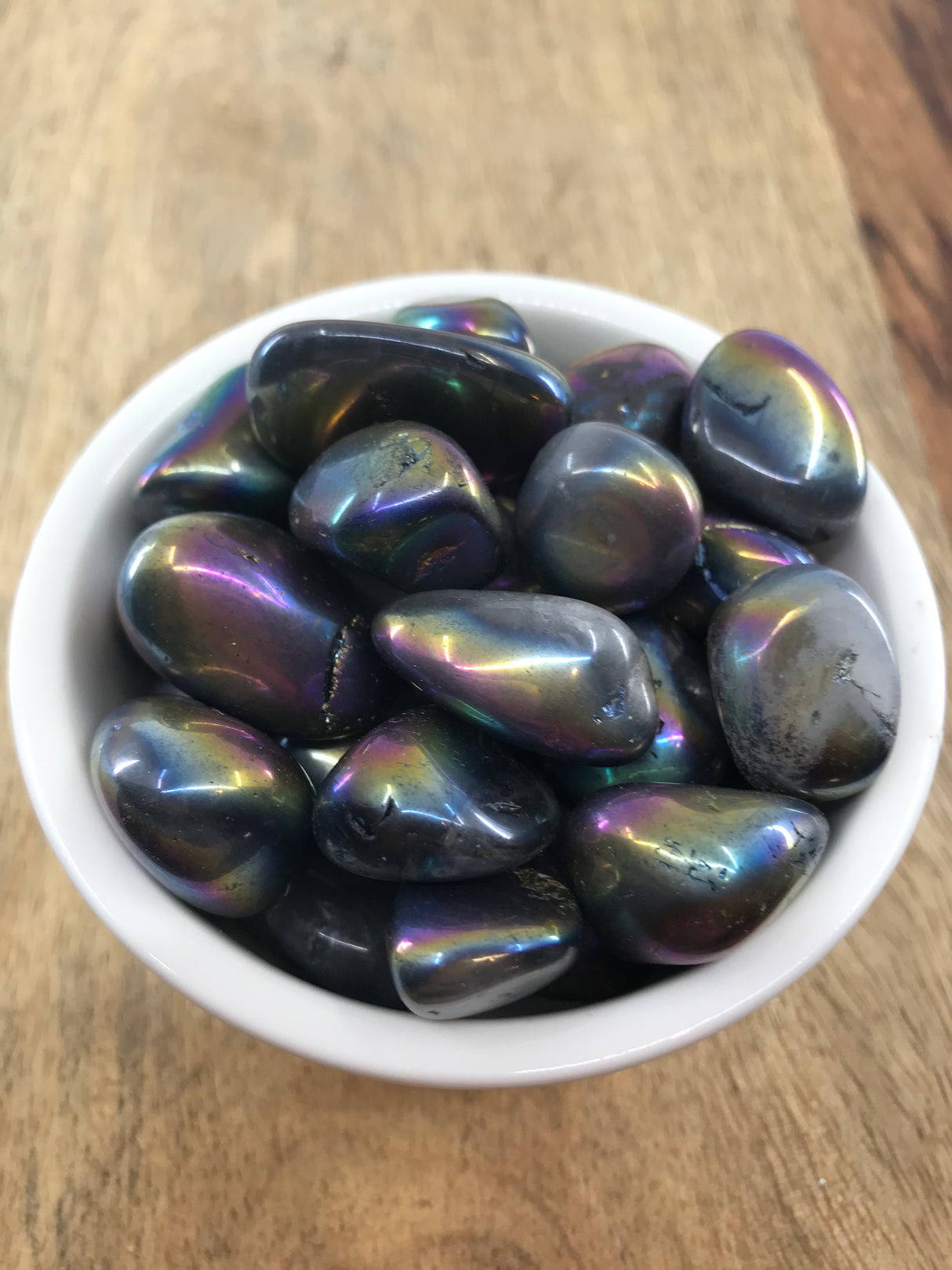 Titanium Flame Aura Quartz tumbled stone with rainbow metallic shimmer — crystal of empowerment, joy, and vitality.