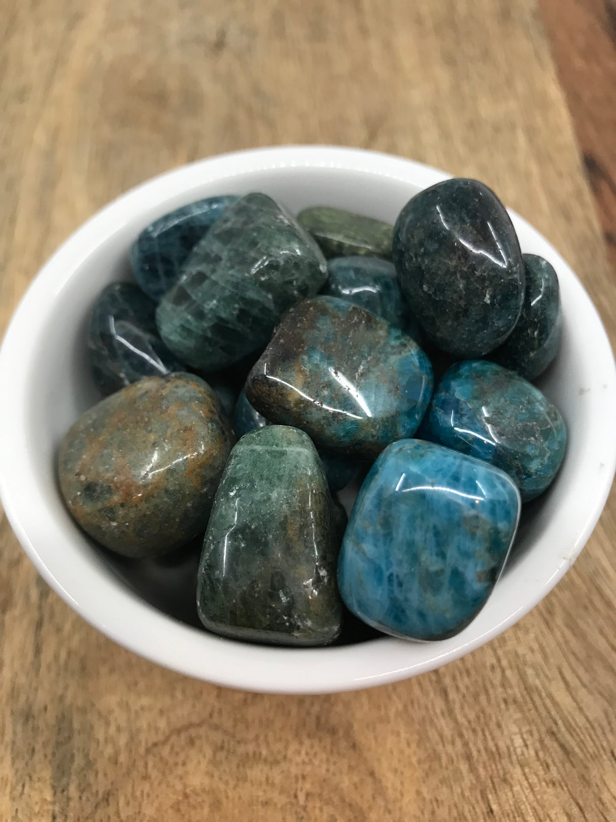 Green Apatite tumbled stone in soft green tones — crystal of healing, abundance, and heart expansion.