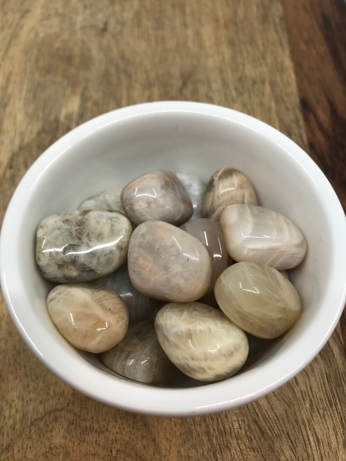 Peach Moonstone tumbled stone in soft peach and cream tones — crystal of love, self-acceptance, and emotional balance.
