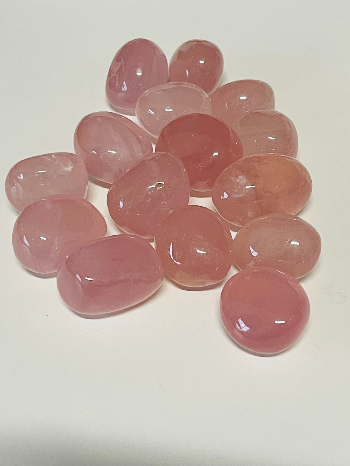 A Grade Rose Quartz tumbled stone in soft pink tones — premium crystal of unconditional love, peace, and compassion.