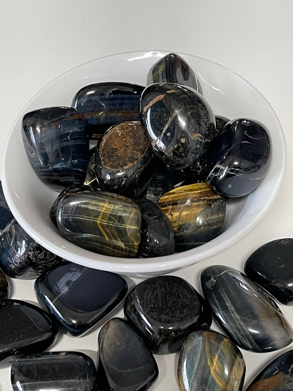 Blue Tiger Eye tumbled stone with silky blue shimmer — crystal of insight, calm, and protection.