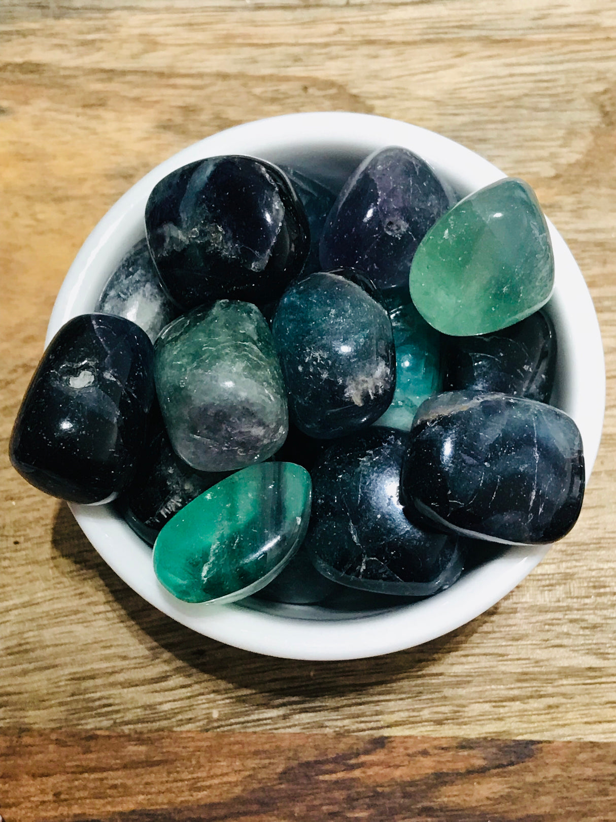 Rainbow Fluorite tumbled stone with purple, green, and blue bands — crystal of clarity, focus, and spiritual harmony.