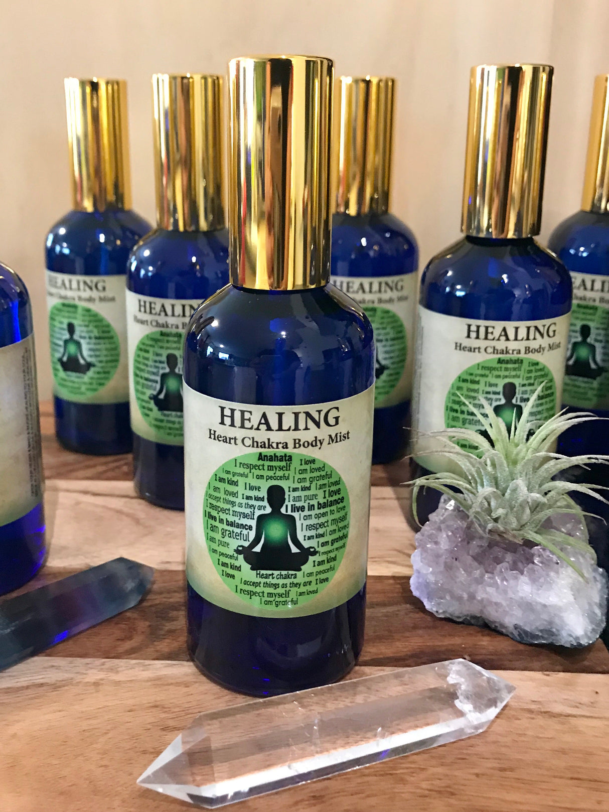 Healing Chakra Mist in a 100ml glass bottle with gold atomiser, infused with Lavender, Mandarin, Cedarwood, Bergamot, Clary Sage, and Vetiver oils, crystal-charged and Reiki-activated by Inspired By 3.