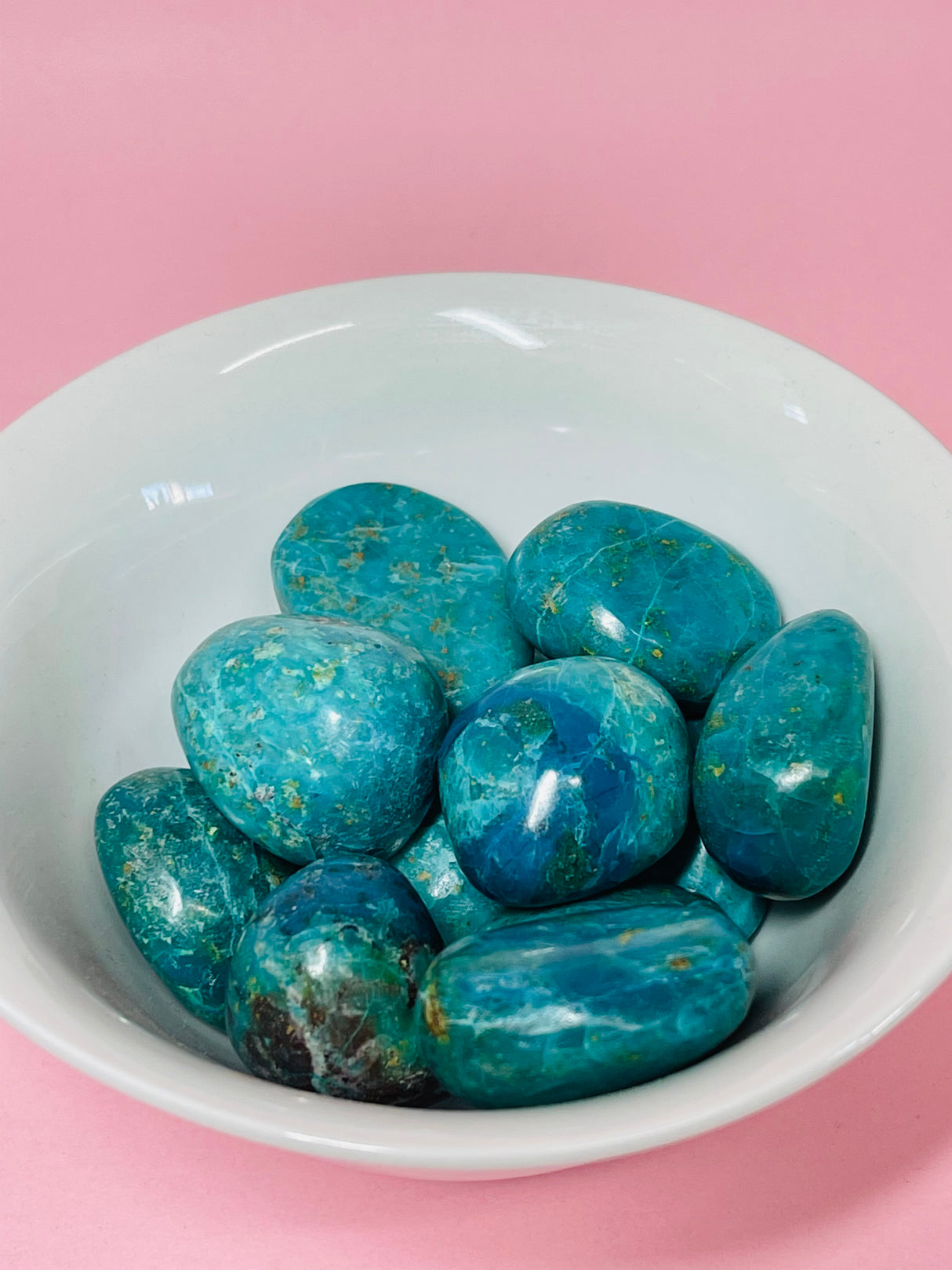 Chrysocolla tumbled stone in ocean-blue and green tones — crystal of communication, empowerment, and inner peace.