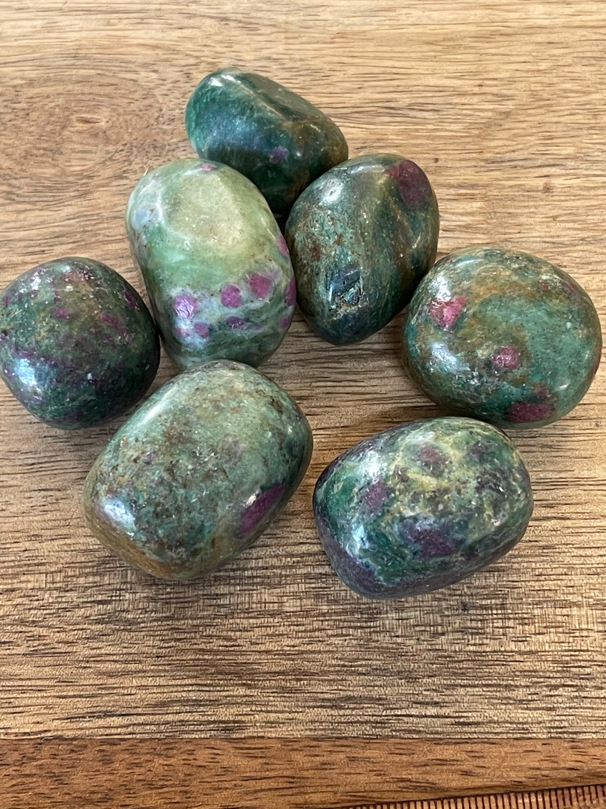 Ruby Zoisite tumbled stone with green and pink-red tones — crystal of passion, growth, and transformation.