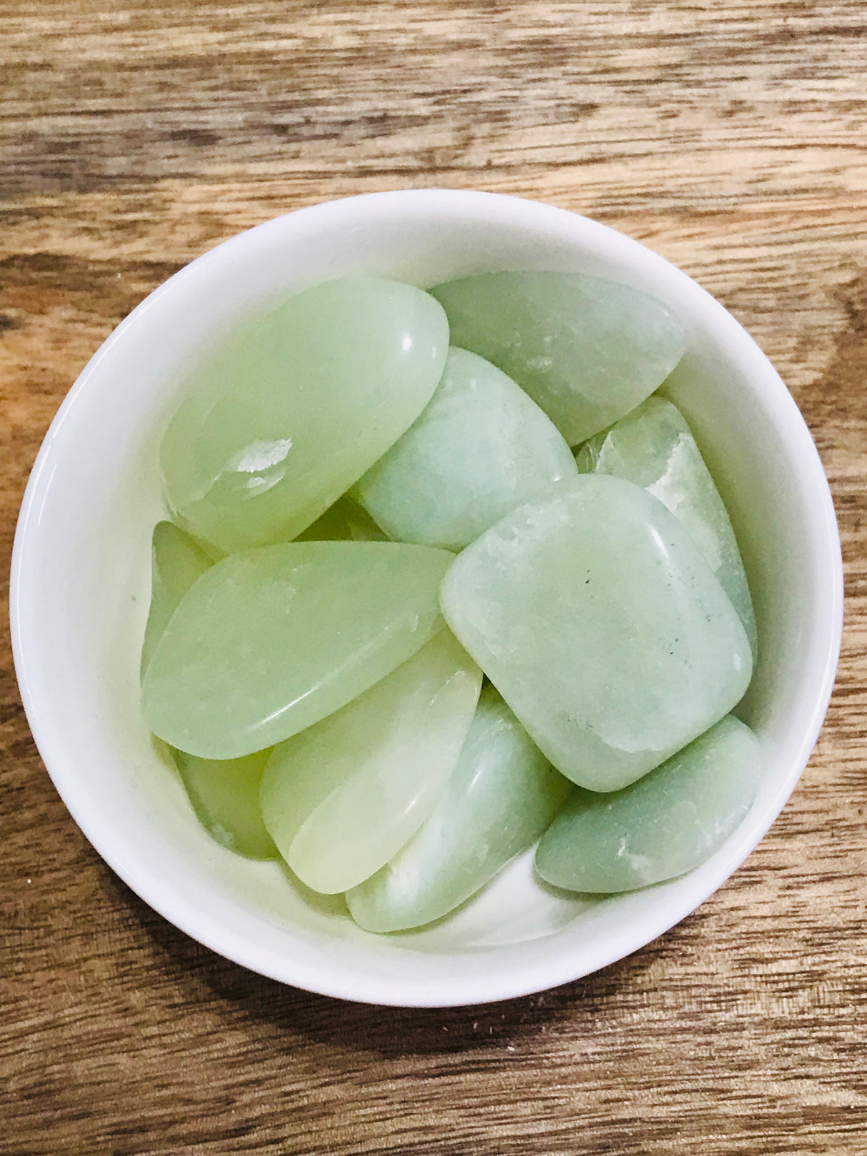 New Jade tumbled stone in soft green tones — crystal of renewal, healing, and gentle protection.