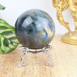 6cm Labradorite sphere weighing 297g with blue and gold labradorescence on a silver stand.