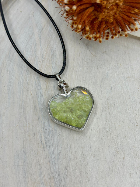 Peridot Heart Bottle Pendant 40x32x11mm filled with crystal chips. For renewal, abundance & joy. Inspired By 3 Crystals Australia.