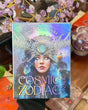Cosmic Zodiac Oracle card deck by Jena Dellagrottaglia with holographic celestial artwork and mystical zodiac-themed design.