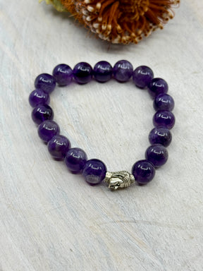 Amethyst stretch bracelet with stainless steel Buddha charm – 10mm natural beads, 6cm inner diameter – purple crystal bracelet for calm, intuition and protection – Inspired By 3 Crystals Australia.
