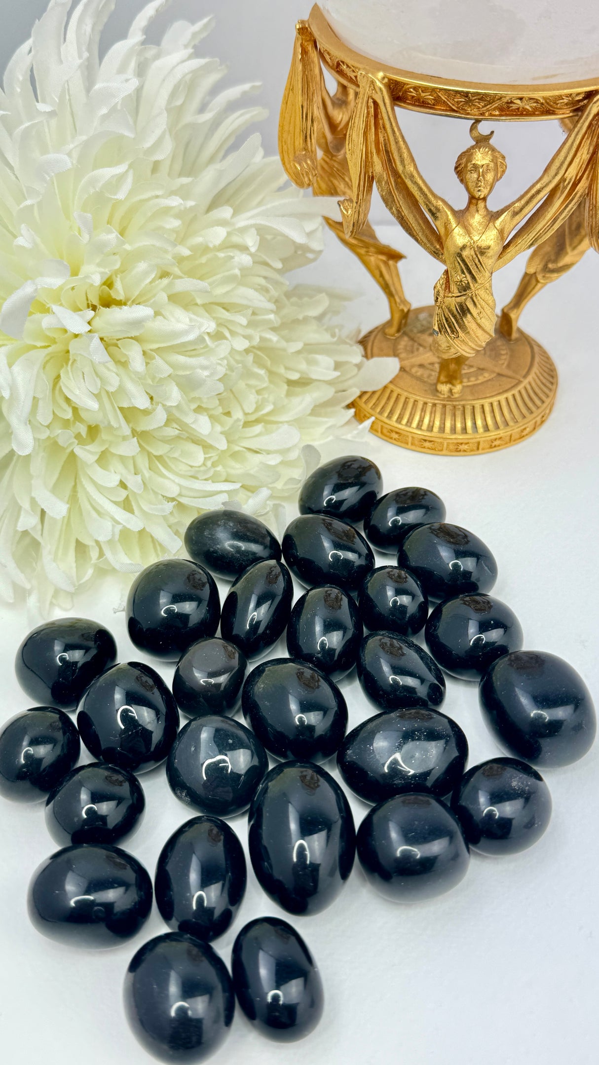 Black Obsidian tumbled stone with glossy finish — crystal of protection, truth, and deep transformation.