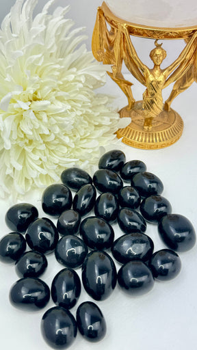 Black Obsidian tumbled stone with glossy finish — crystal of protection, truth, and deep transformation.