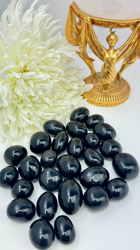 Black Obsidian tumbled stone with glossy finish — crystal of protection, truth, and deep transformation.
