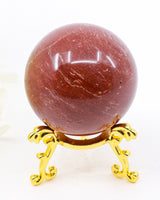 Natural Red Jasper crystal sphere approximately 5cm with deep earthy red colouring and crystal sphere stand