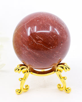 Natural Red Jasper crystal sphere approximately 5cm with deep earthy red colouring and crystal sphere stand